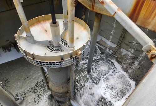 Interior and bow of a hopper dredge. View of the pipe transporting OCS sand from the dredge to the OBX shore. 