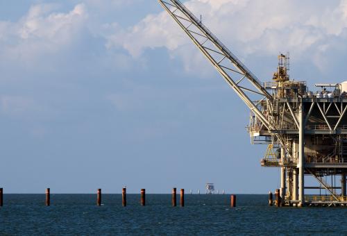 Gulf of Mexico oil rig against a cloudy blue sky